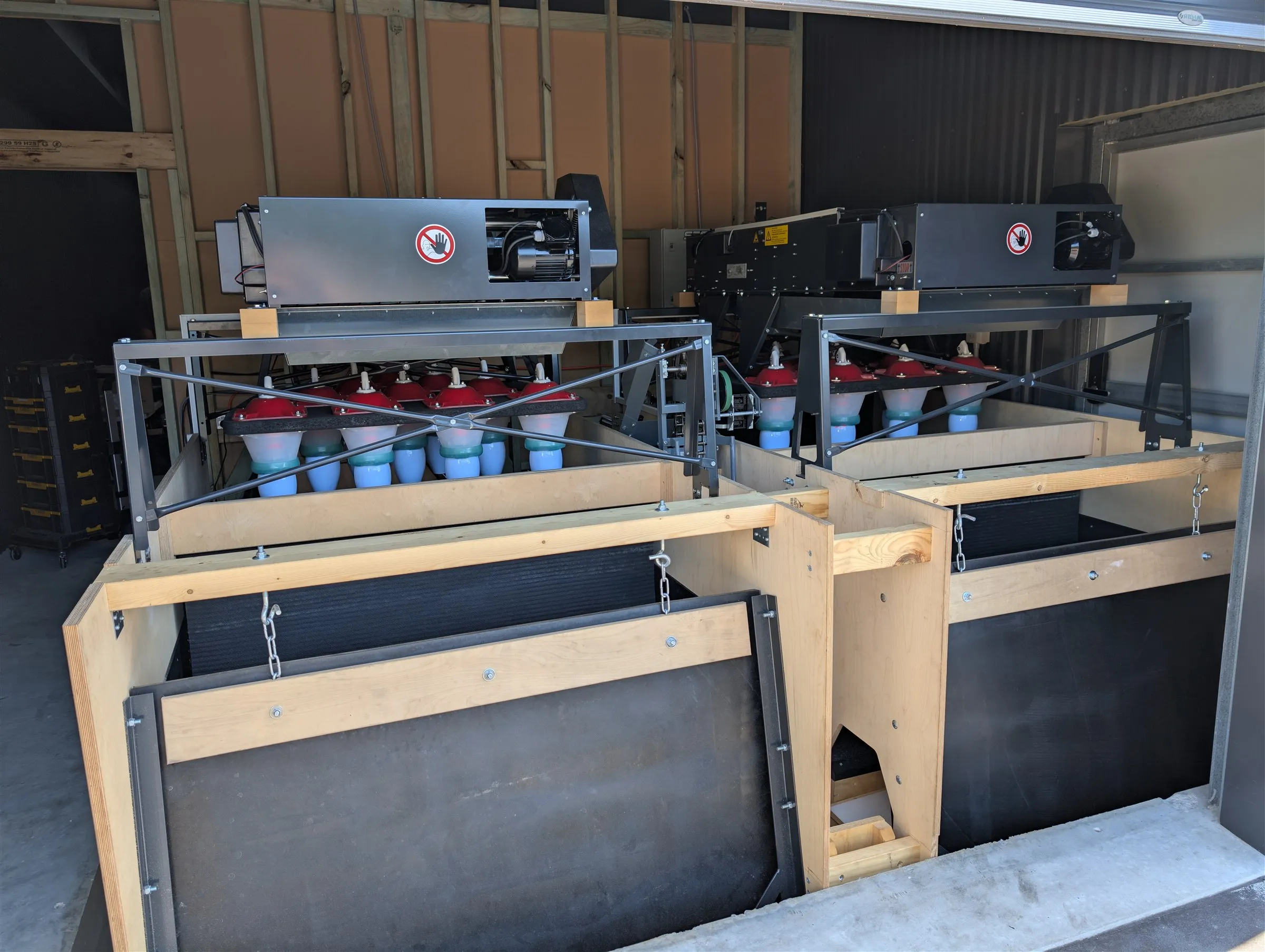 Two string pinsetters installed on their timber substructure in the machine room behind the pins
