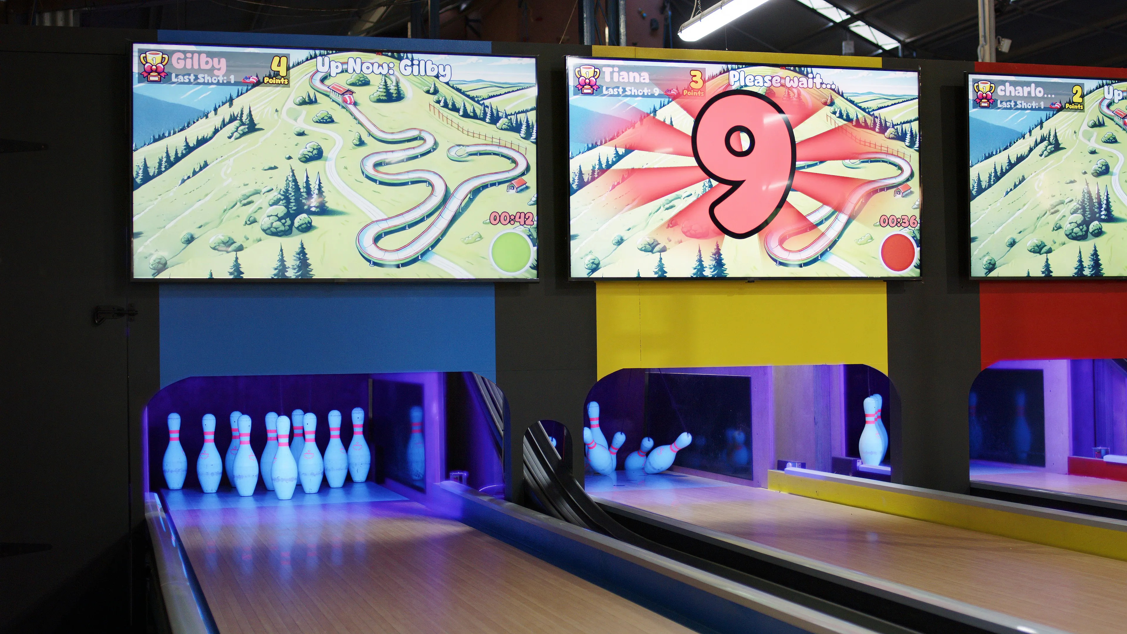 LaneCraft game modes running across three lane screens above UV-lit pin decks